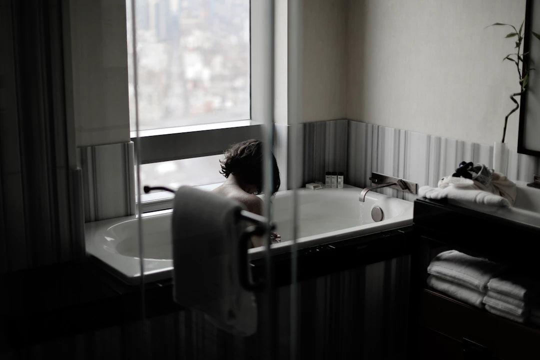 a person in a bathtub in a bathroom